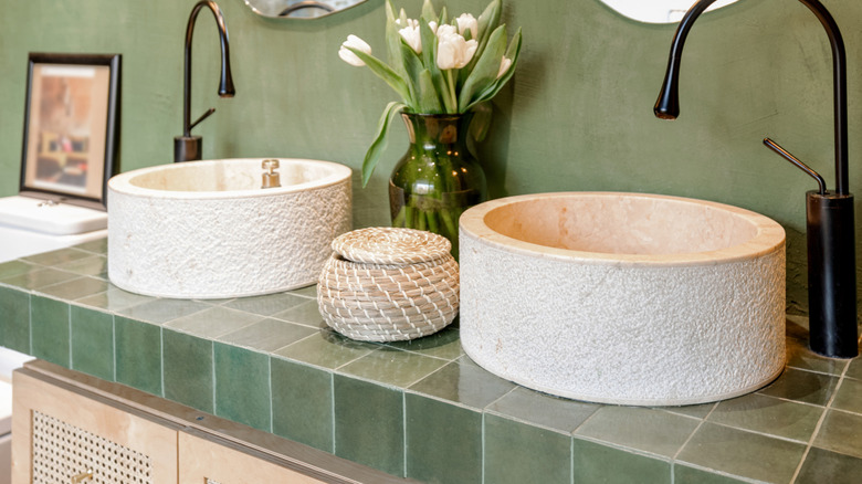 A green bathroom with organic details.