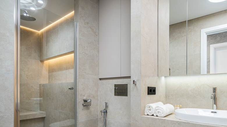 A modern bathroom with large stone tiles.