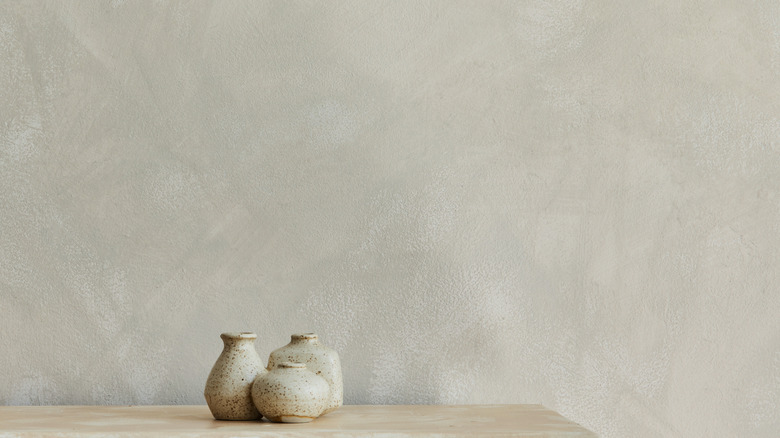 A close up on a limewash painted wall and a shelf.