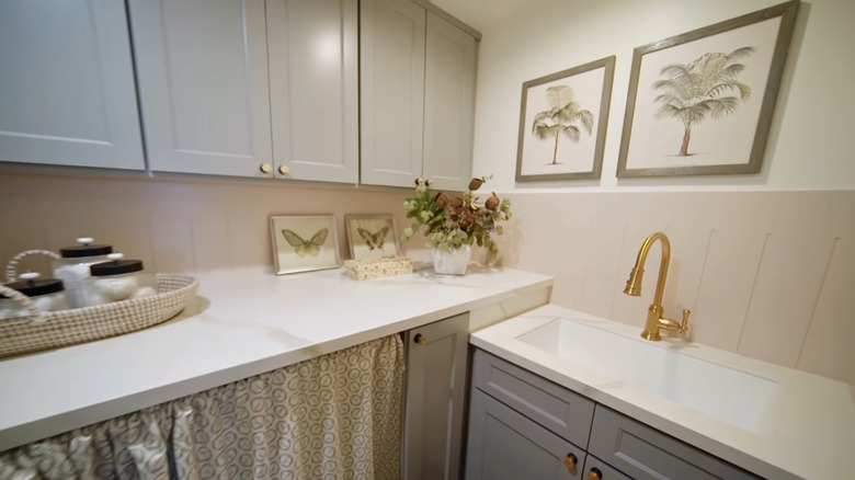 A small laundry room with a sink.