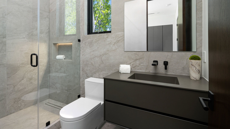 Small modern bathroom with new toilet.
