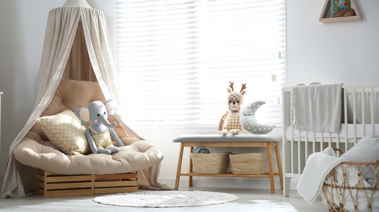 Toys and other items stored in a shoe storage bench in a kid's room.