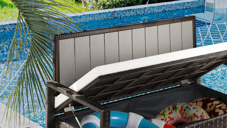 A shoe storage bench used outdoors for storing swimming pool equipment.