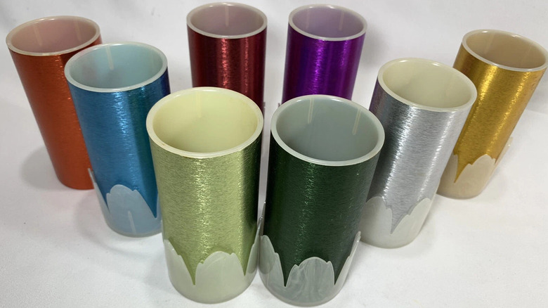 An assortment of rainbow colored lined aluminum tumblers are shown in detail
