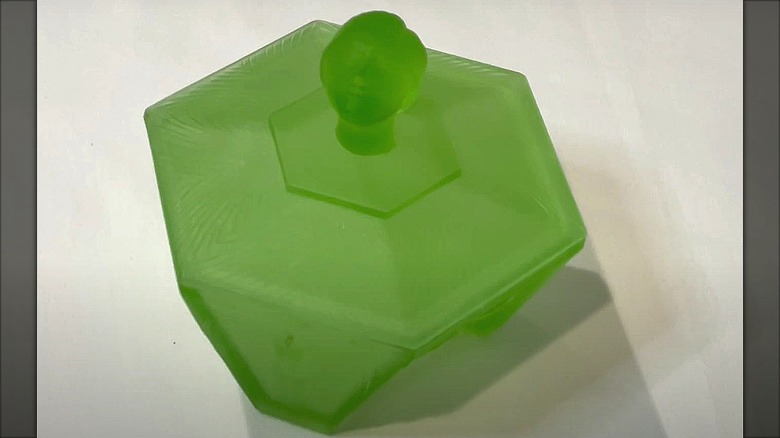 A Ramses green satin glass powder box with flapper head finial