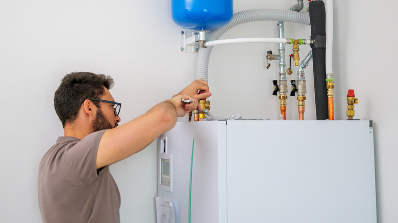 Man fixing an issue on his water heater himself