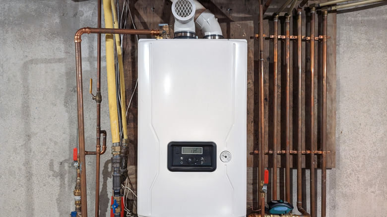 A water heater unit in a space with uninsulated concrete walls