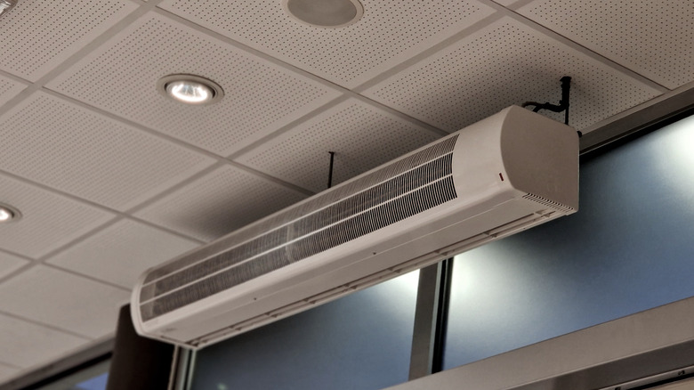 Air curtain machine installed over doors of commercial space
