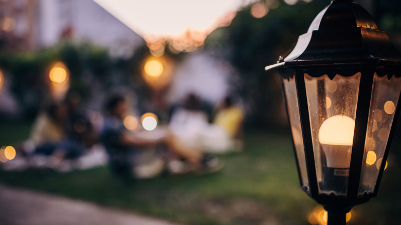 Warm yellow lights at dusk outside a home