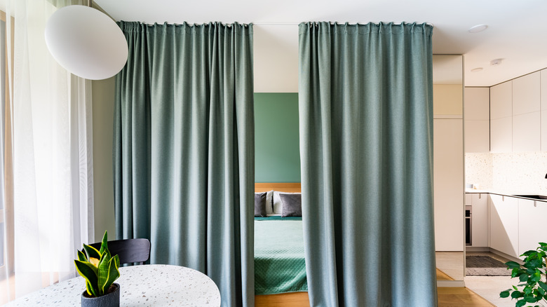 Curtains hanging in the middle of an apartment.