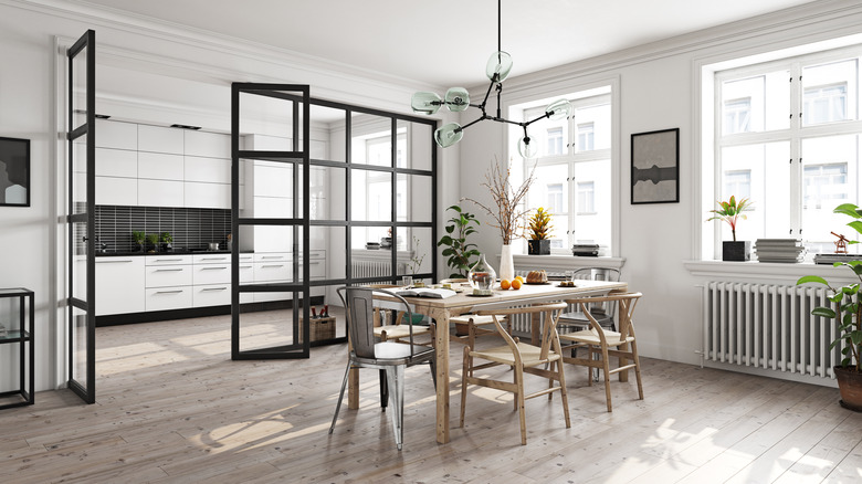 A glass partition wall separating the kitchen and dining room.