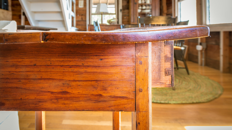 warped wooden desk with drawer