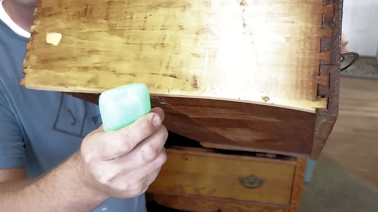 man applying soap to edge of vintage drawer