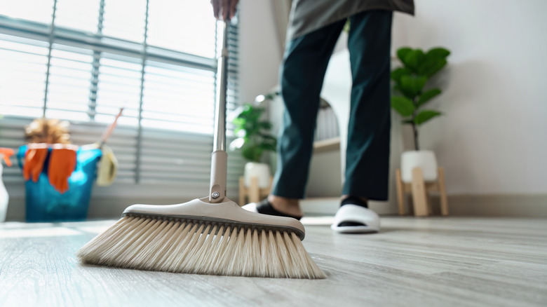 A person sweeping the floor in their house