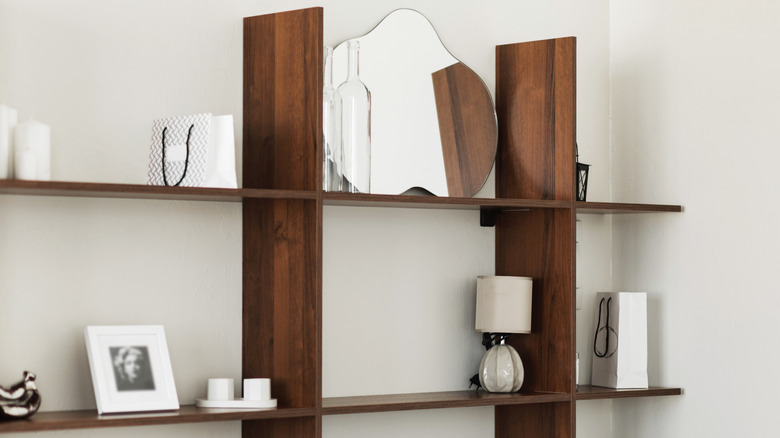 Wood bookshelf with mirror and decorations