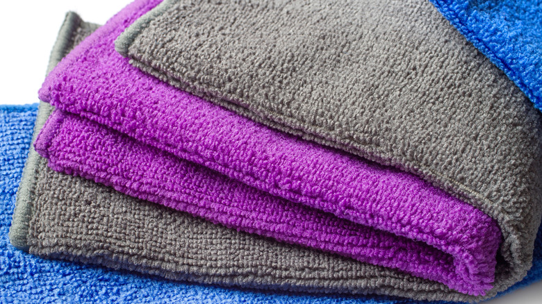 A set of folded microfiber cloths in various colors