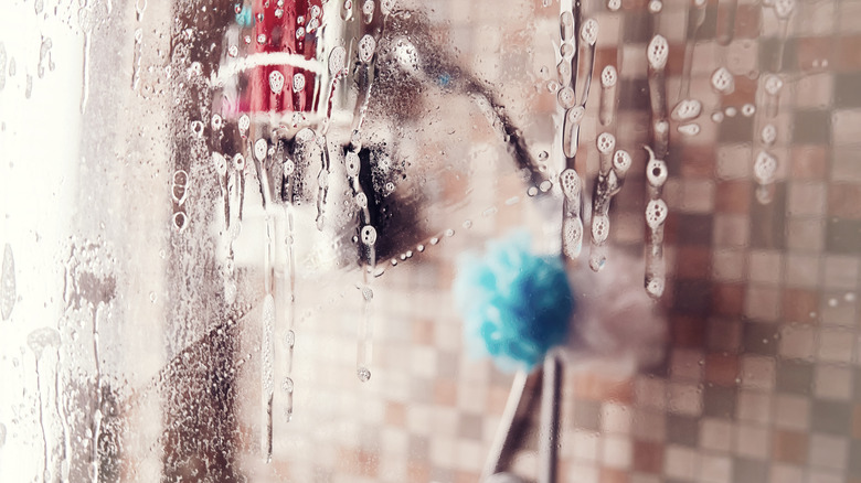 Water and suds dripping down a glass shower door