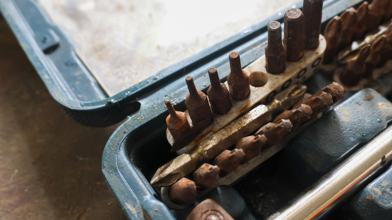 A rusty wrench lies next to an identical shining, clean wrench