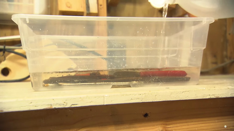 Tools in a tub of vinegar