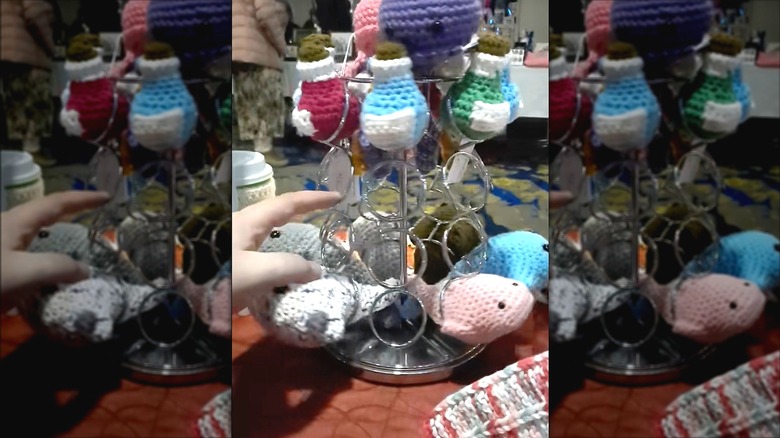 Metal K-cup holder turned into a holder for crocheted small animals at a craft event