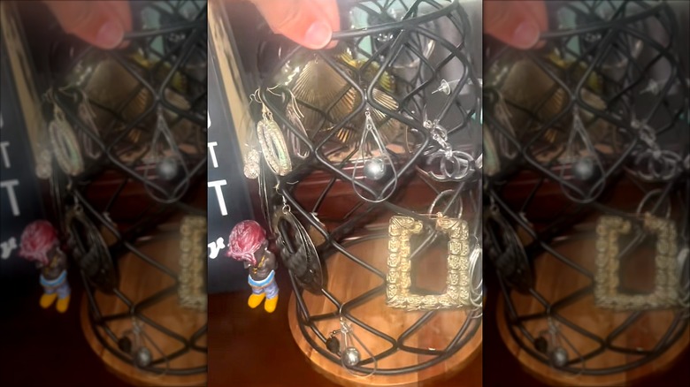 Multiple earrings hung on a K-cup holder