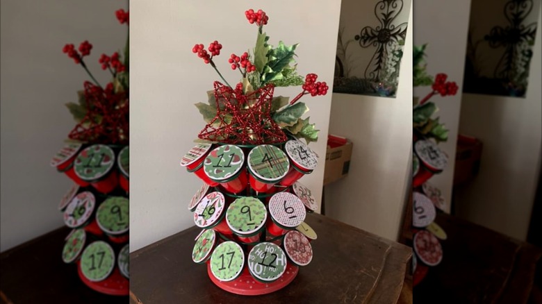Advent calendar created with K-cup holder, each cup decorated with Christmas wrapping paper