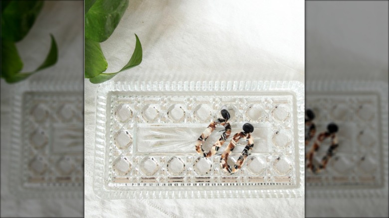 Earrings in flat glass dish