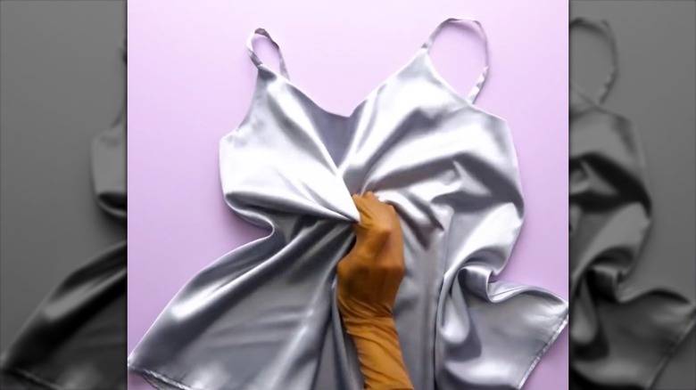 tights over hand grabbing top to wash