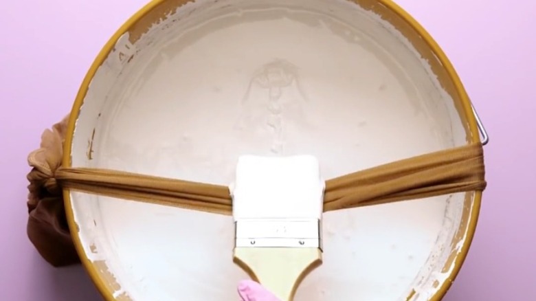 tights stretched over paint can