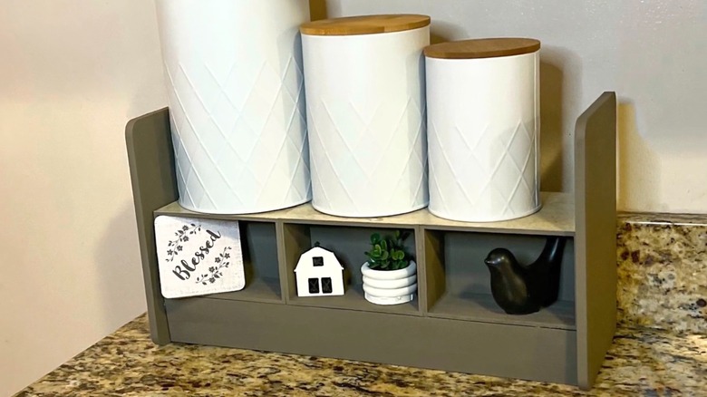 Farmhouse style countertop shelf made from Dollar Tree cutting boards and crates.