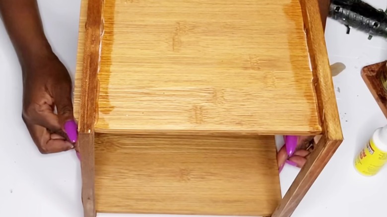 Storage shelf unit made from Dollar Tree cutting boards and old wooden frames.
