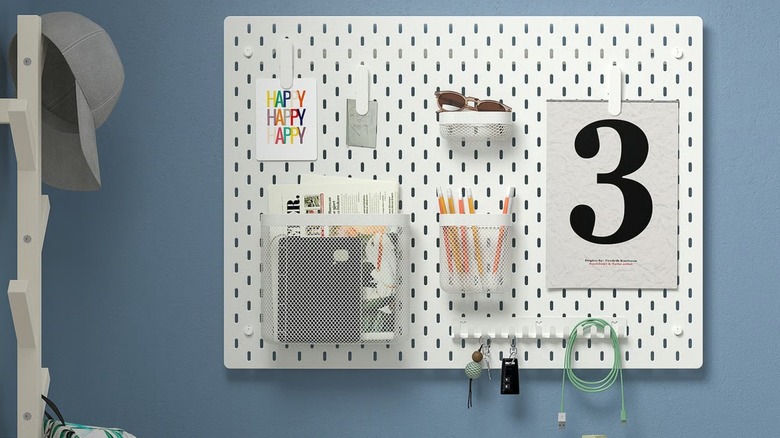 IKEA SKÅDIS pegboard holding sunglasses, notes, pencils, and smaller items