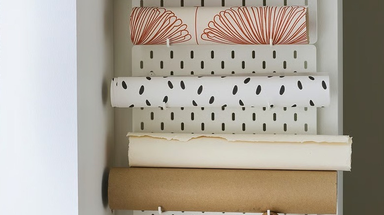 IKEA SKÅDIS holding rolls of wrapping paper