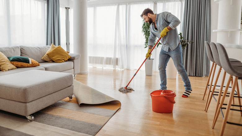man mopping hardwood