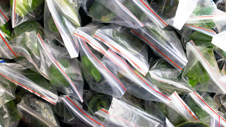 Overhead shot of plastic bags filled with greens
