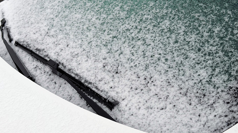 Winter frozen car window and windshield wiper