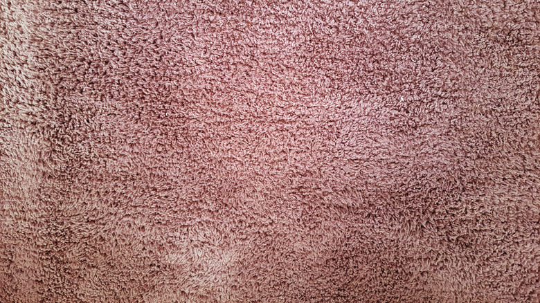 A close up on a light pink 1980s carpet.