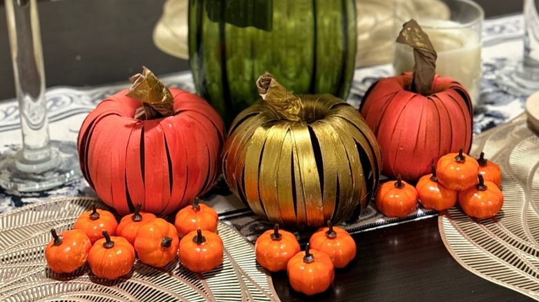 Classy toilet paper pumpkins on dining room table runner