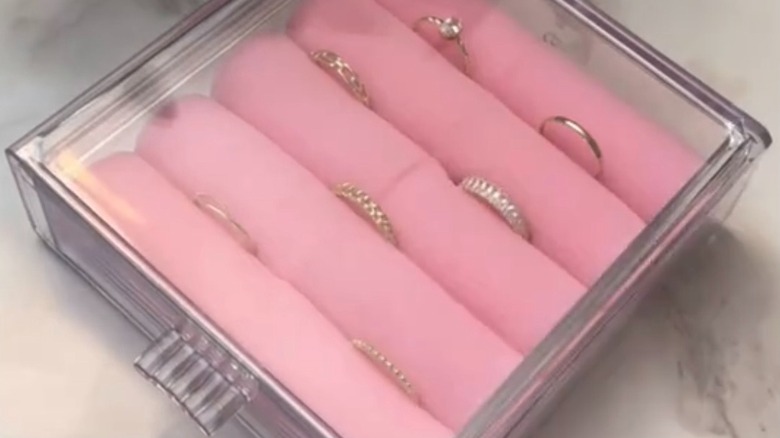 close up of clear plastic container with foam rollers to create DIY jewelry box