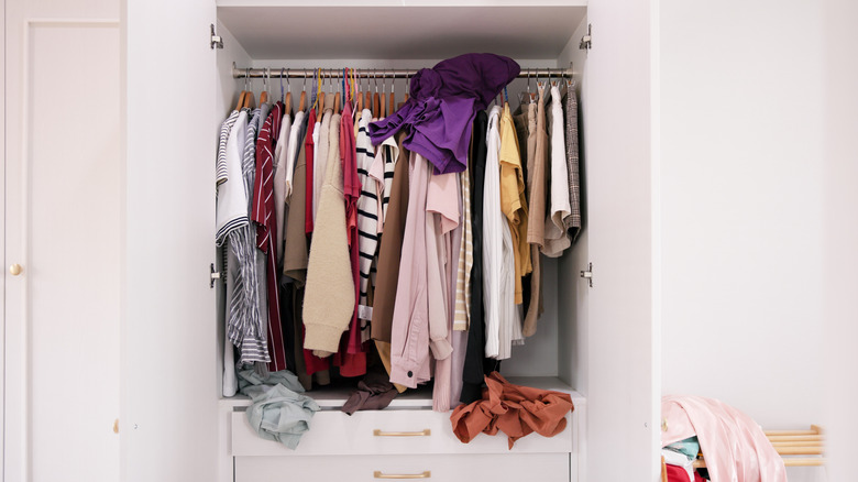 Messy small reach-in closet lacking organization