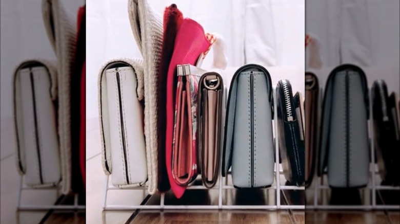 clutches and wallets stored in dish rack for DIY small closet solution