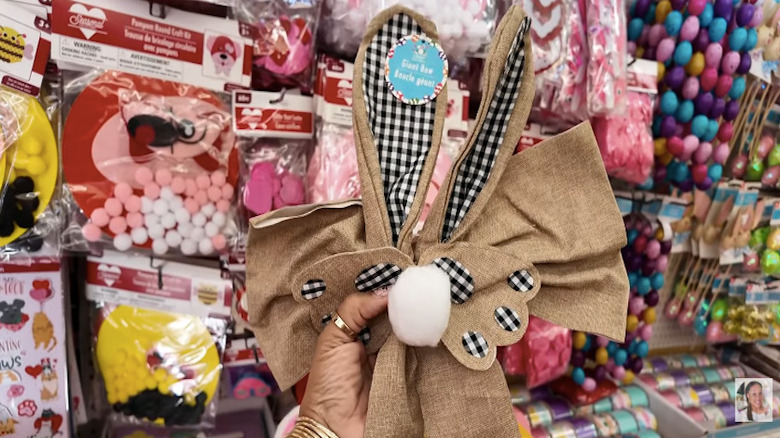 Close up of person holding up Dollar Tree Easter themed giant bow