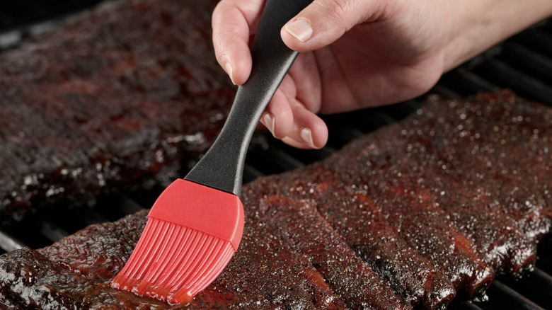Expert Grill Basting Brush being used on ribs on a grill