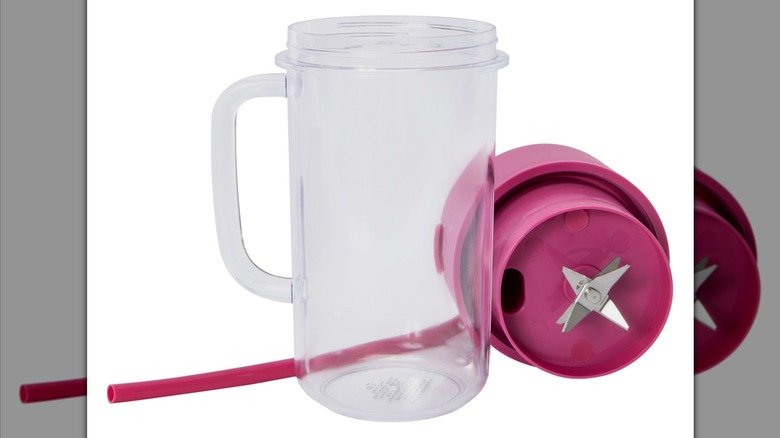 A handled drinking container with a silicon straw and a blender lid