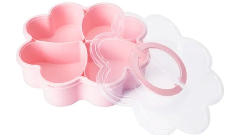 A pink, flower shaped plastic container