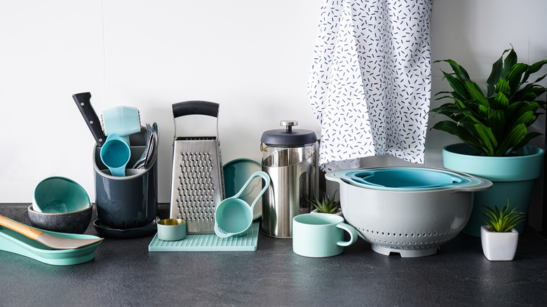 A selection of kitchen tools and utensils on a bench