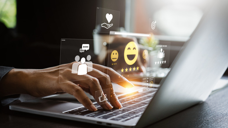 A person providing an online review on a laptop