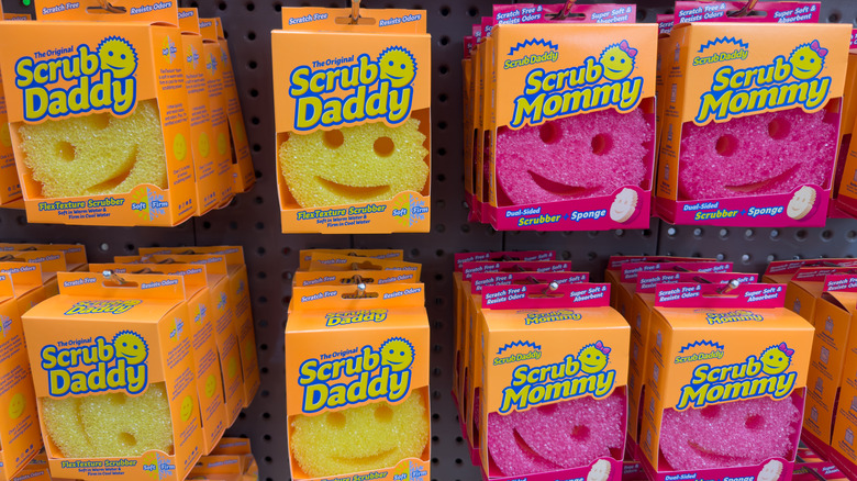 Pink and yellow Scrub Daddy and Scrub Mommy brand sponges in a store