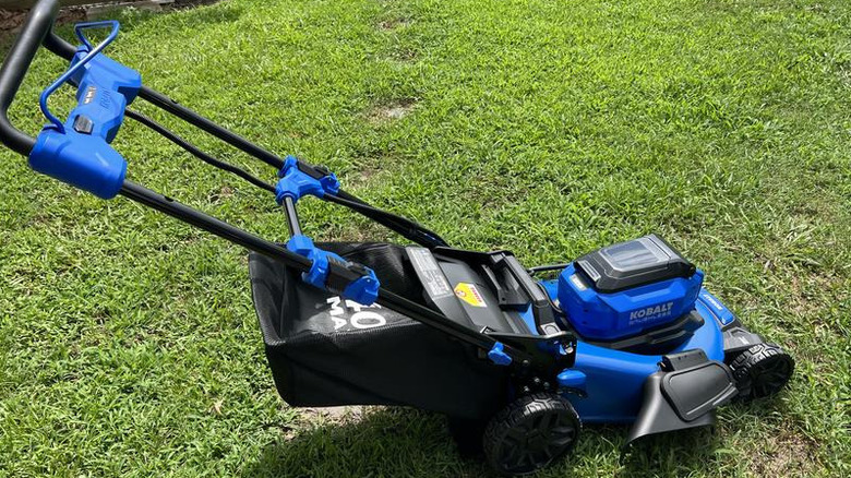 Blue Kobalt battery mower on short lawn during the day