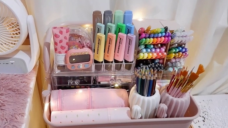Pink RASKOG cart with art supplies on top shelf
